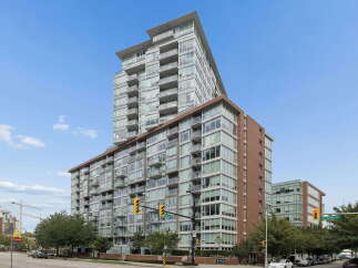 Discover modern urban living in this stunning high-rise condominium, featuring a striking architectural design with expansive glass balconies offering panoramic city views.