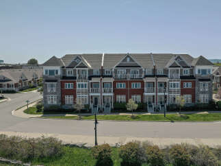 Discover modern living in this stunning row of townhouses, featuring elegant brick and stone exteriors.