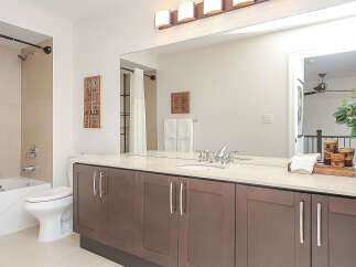 This modern bathroom features a spacious vanity with ample storage and a sleek countertop.