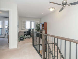 This spacious home office features a large desk with an ergonomic chair, perfect for productivity.