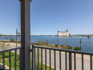 Enjoy breathtaking waterfront views from this stunning property, featuring a spacious balcony overlooking the serene blue waters.