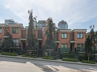 Discover modern urban living in this stunning row of townhouses, featuring elegant brick exteriors and contemporary architectural details.