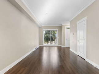 Step into this bright and airy living space, featuring rich hardwood floors that gleam under recessed lighting.