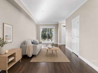 Step into this beautifully staged living room, featuring a comfortable grey sofa adorned with a cozy throw and accent pillows.