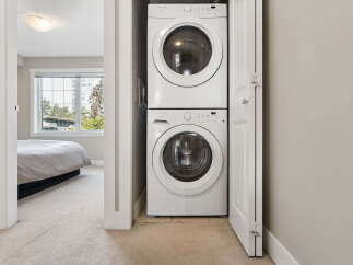 Discover convenient in-suite laundry with this stacked washer and dryer unit, perfect for modern living.