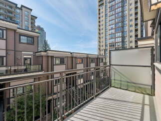 Enjoy your morning coffee on this private balcony, offering a serene view of the surrounding urban landscape.