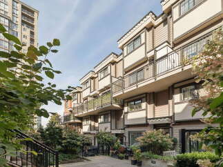 Discover modern urban living in this stunning townhouse complex, featuring a contemporary facade with warm wood accents and elegant balconies.