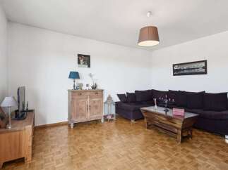 This living room features a spacious dark sectional sofa perfect for relaxation and entertaining.