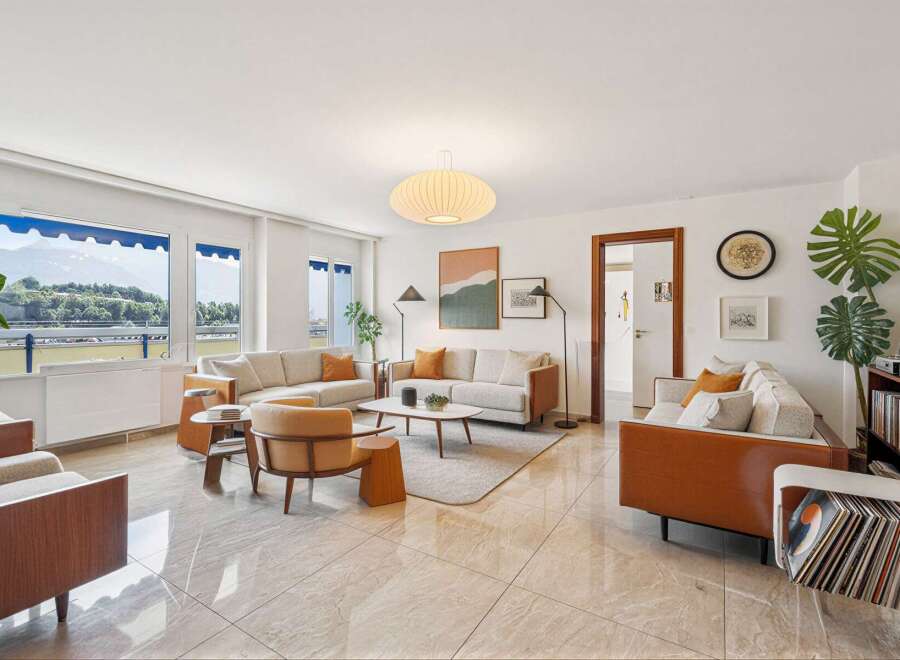 Experience modern living in this spacious living room, featuring a comfortable sectional sofa and elegant accent chairs.