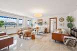 Experience modern living in this spacious living room, featuring a comfortable sectional sofa and elegant accent chairs.