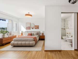 Experience modern comfort in this beautifully appointed bedroom, featuring a plush, low-profile bed and elegant bedside tables.