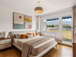 Experience modern comfort in this beautifully appointed bedroom, featuring a plush upholstered bed and tasteful abstract art.
