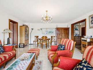 Step into this inviting living and dining area, featuring a classic wooden dining set with four chairs, perfect for intimate meals.