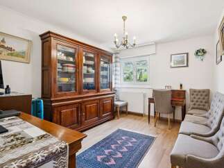 This dining room features a large, traditional wooden hutch filled with dishes, perfect for storage and display.