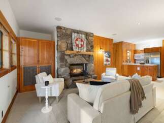 Experience rustic charm in this inviting living space, featuring a magnificent stone fireplace as the centerpiece.