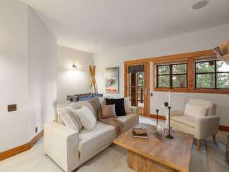 Cozy living room with a foosball table and a ski-themed poster, perfect for family fun.