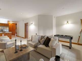 This inviting living space features a comfortable sofa and armchair, perfect for relaxing.