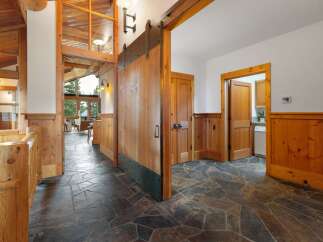 Experience rustic charm and modern convenience in this stunning entryway, featuring a grand wooden barn door that adds a unique architectural element.