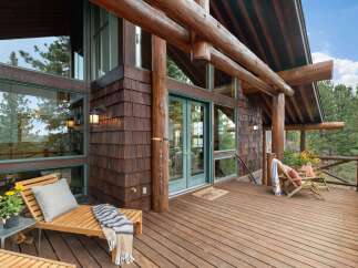 Experience rustic charm and stunning natural beauty from this expansive wooden deck, perfect for outdoor living.