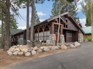 Experience rustic charm and modern comfort in this stunning mountain home, featuring a grand log-beam entrance and a spacious covered patio perfect for enjoying the serene surroundings.