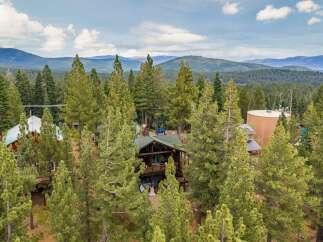 Nestled amidst a lush pine forest, this stunning property offers a serene mountain retreat.