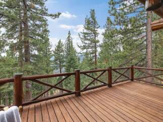 Experience breathtaking mountain views from this expansive wooden deck, perfect for outdoor living and entertaining.