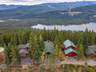 Nestled amidst a dense forest with a stunning lake and mountain backdrop, this property offers a serene retreat.