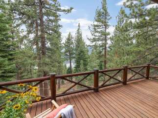 Enjoy breathtaking lake and mountain views from this expansive wooden deck, perfect for outdoor entertaining or quiet relaxation.