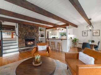 Experience cozy living in this stunning home featuring a magnificent stone fireplace as the centerpiece of the living area.
