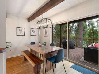 Enjoy cozy meals in this charming dining area featuring a rustic wooden table with a matching bench and chairs.