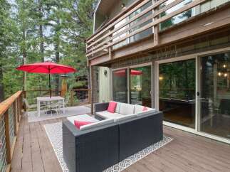 Enjoy the outdoors on this spacious deck, perfect for entertaining or relaxing amidst the trees.