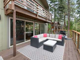 Enjoy outdoor living on this spacious deck, perfect for entertaining or relaxing amidst the trees.
