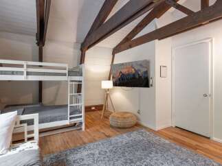 This charming room features a space-saving bunk bed, perfect for families or groups.