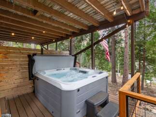 Relax and unwind in this luxurious hot tub, perfect for enjoying the serene mountain views.