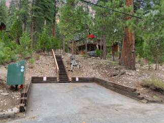 Discover this charming mountain retreat nestled among tall pine trees, offering a serene escape.