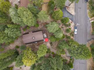 Discover this charming cabin nestled amongst mature trees, offering a serene retreat.