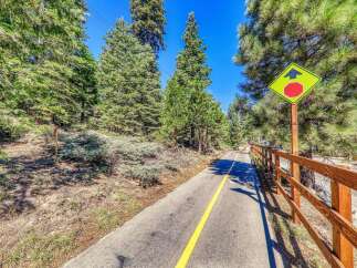 Enjoy the scenic beauty of this property with its paved walking path, perfect for leisurely strolls or bike rides amidst lush greenery.
