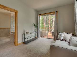 Step into this inviting living space featuring a plush carpet and a comfortable sofa, perfect for relaxation.