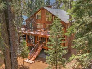 Experience mountain living in this stunning wooden lodge, nestled amongst tall pine trees.
