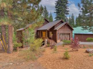 Nestled amidst tall pine trees, this charming wooden home offers a serene mountain retreat.