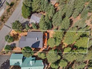 Discover this charming property nestled amongst mature trees, offering a private and serene setting.