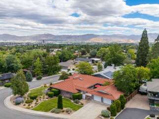 Discover this stunning home featuring a durable and attractive red tile roof, perfect for any climate.