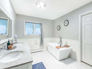 Indulge in luxury with this stunning bathroom featuring a freestanding soaking tub, perfect for unwinding after a long day.