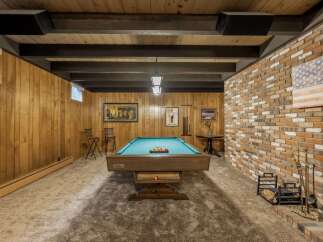 Step into this ultimate game room, featuring a classic pool table ready for your next match.