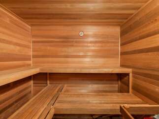 Experience ultimate relaxation in this luxurious cedar sauna, featuring multi-level benches for personalized comfort.