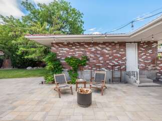 Enjoy outdoor living in this charming backyard featuring a spacious paver patio perfect for entertaining.