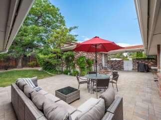 Enjoy outdoor living in this spacious backyard featuring a large paved patio perfect for entertaining.