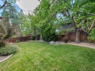 Enjoy the expansive backyard with a lush green lawn, perfect for outdoor activities and relaxation.