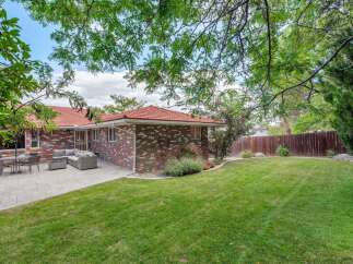 Enjoy outdoor living in this spacious backyard featuring a large paved patio perfect for entertaining.