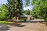 Nestled amidst mature trees, this charming brick home offers a serene retreat.